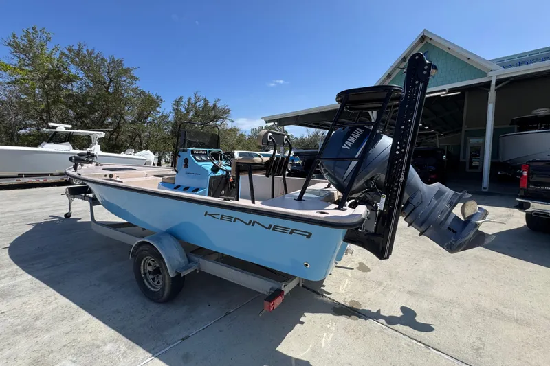 Slide: The Image of 2004 Kenner 21 VX boat with Yamaha motor on trailer, parked outdoors. - 15