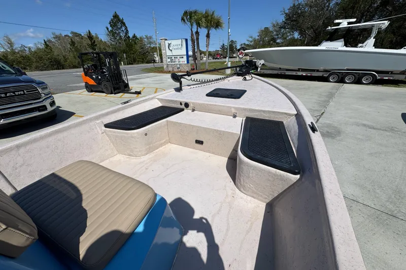 Slide: The Image of 2004 Kenner 21 VX boat interior with seating and storage compartments. - 16