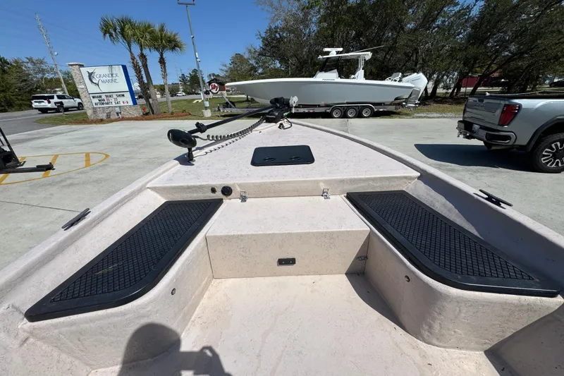 Slide: The Image of 2004 Kenner 21 VX boat deck with seating, parked at Grande Marine dealership. - 17