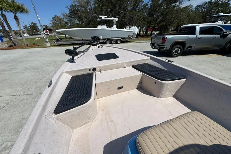 Slide: The Image of 2004 Kenner 21 VX boat interior with seating and storage compartments. - 18