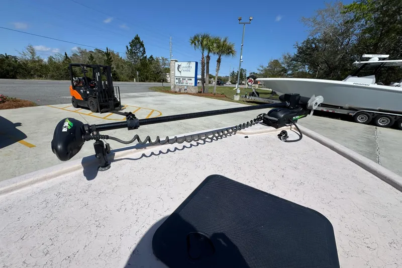 Slide: The Image of 2004 Kenner 21 VX boat with trolling motor in marina parking lot. - 23