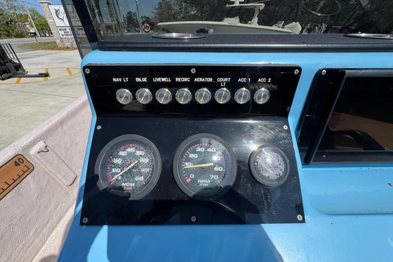 Slide: The Image of Dashboard of a 2004 Kenner 21 VX boat with gauges and switches. - 34