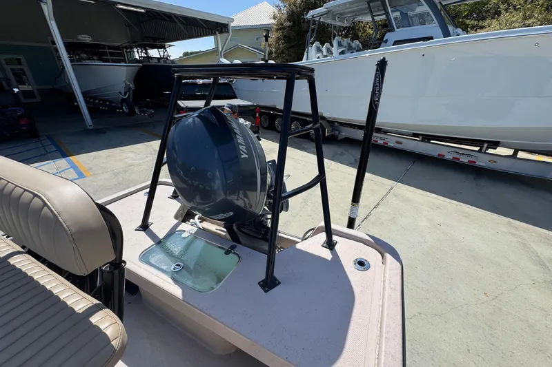 Slide: The Image of 2004 Kenner 21 VX boat with Yamaha outboard motor in a marina setting. - 37