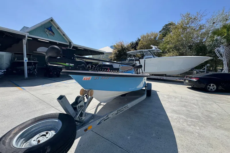 Slide: The Image of 2004 Kenner 21 VX boat on trailer at marina, sunny day. - 4