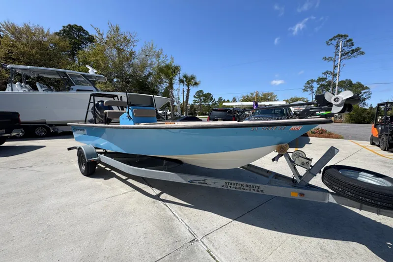 Slide: The Image of 2004 Kenner 21 VX boat on trailer, parked outdoors under clear blue sky. - 7