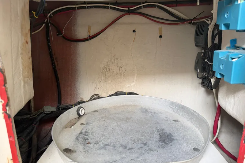 Slide: The Image of 2007 Cobia 312 Sport Cabin interior wiring and equipment compartment. - 11