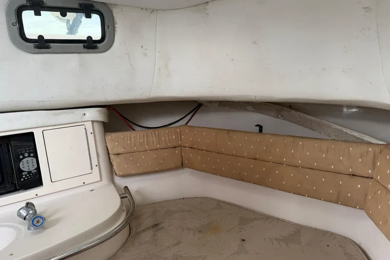 Slide: The Image of 2007 Cobia 312 Sport Cabin interior with cushioned seating and compact sink area. - 13