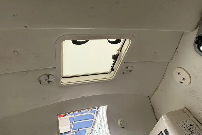 Slide: The Image of 2007 Cobia 312 Sport Cabin interior ceiling with hatch and lighting fixtures. - 14