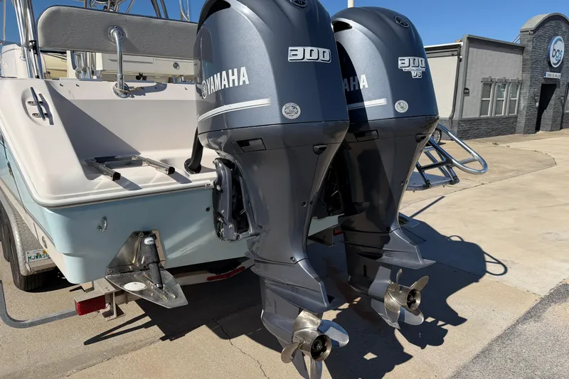 Slide: The Image of 2007 Cobia 312 Sport Cabin with twin Yamaha 300 engines, docked outdoors. - 19