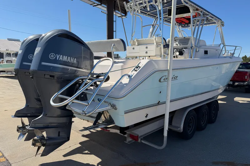 Slide: The Image of 2007 Cobia 312 Sport Cabin boat with dual Yamaha outboard engines on trailer. - 2
