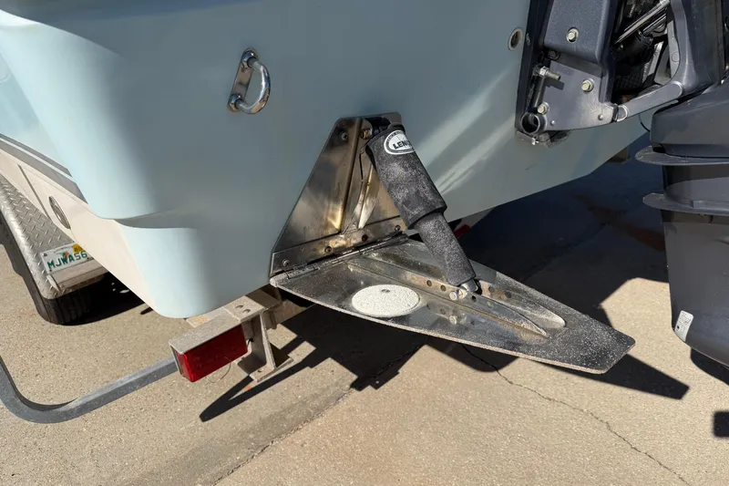 Slide: The Image of 2007 Cobia 312 Sport Cabin boat stern with trim tab and motor detail. - 20