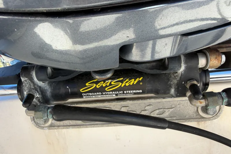 Slide: The Image of SeaStar outboard hydraulic steering on 2007 Cobia 312 Sport Cabin boat. - 23