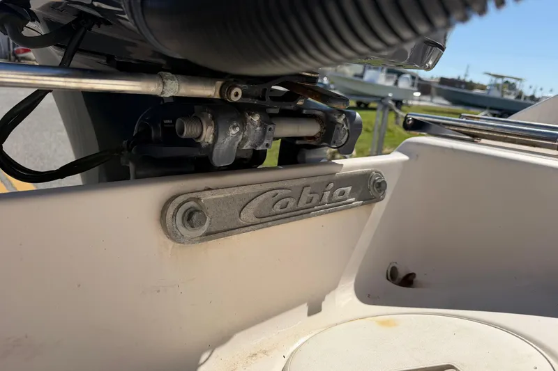 Slide: The Image of Close-up of a 2007 Cobia 312 Sport Cabin boat engine area with logo. - 25
