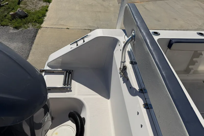 Slide: The Image of 2007 Cobia 312 Sport Cabin boat deck with ladder and seating area. - 26