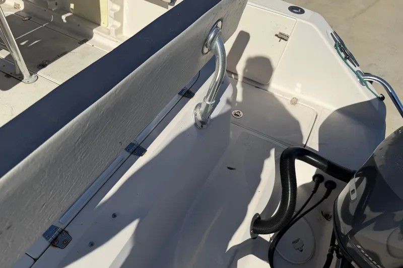 Slide: The Image of 2007 Cobia 312 Sport Cabin boat interior with seating and engine details. - 27