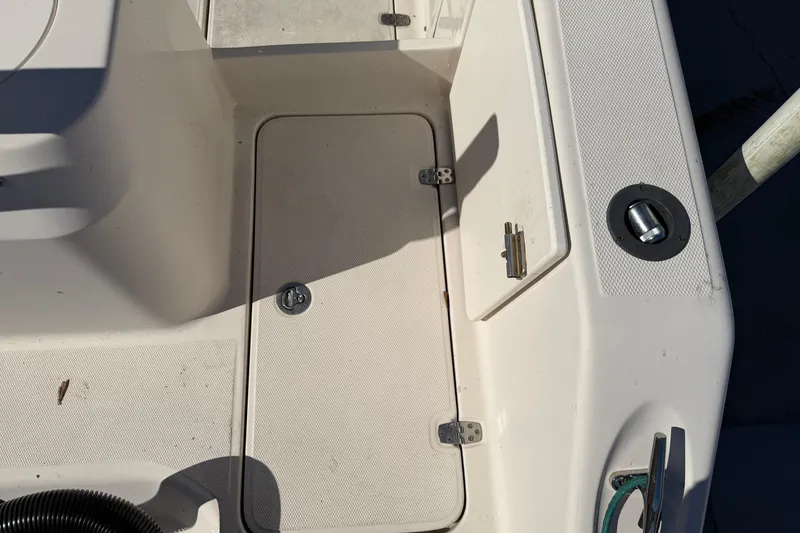 Slide: The Image of 2007 Cobia 312 Sport Cabin deck with storage compartment and latch. - 28