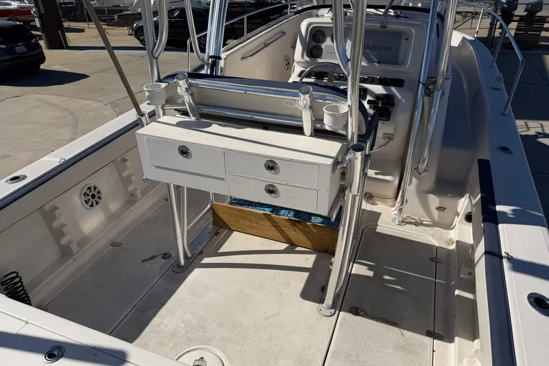 Slide: The Image of 2007 Cobia 312 Sport Cabin boat interior with helm and storage drawers. - 29