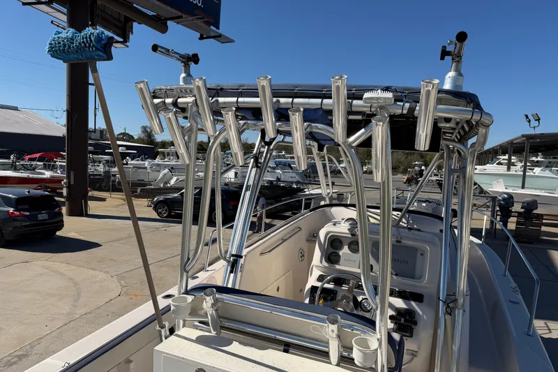 Slide: The Image of 2007 Cobia 312 Sport Cabin boat with rod holders and navigation equipment. - 30
