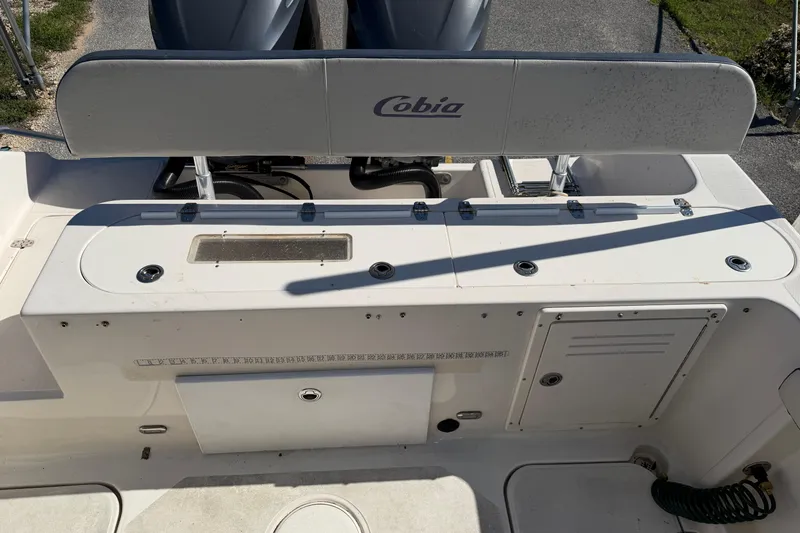 Slide: The Image of 2007 Cobia 312 Sport Cabin boat deck with storage compartments and seating. - 32