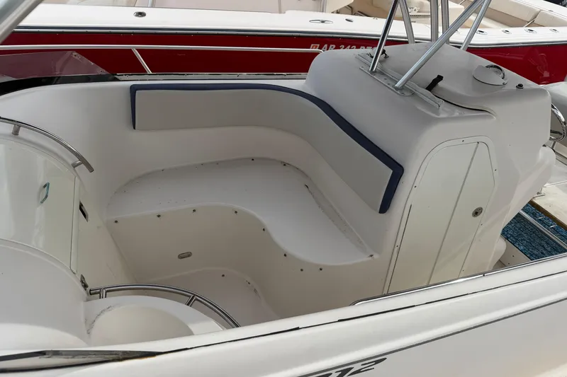 Slide: The Image of 2007 Cobia 312 Sport Cabin interior seating area with white and blue accents. - 7