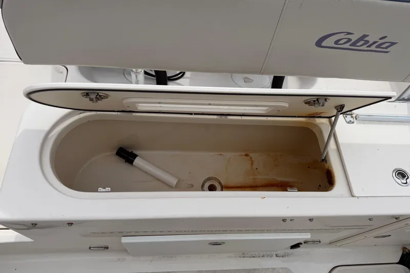 Slide: The Image of Open storage compartment on a 2007 Cobia 312 Sport Cabin boat. - 8