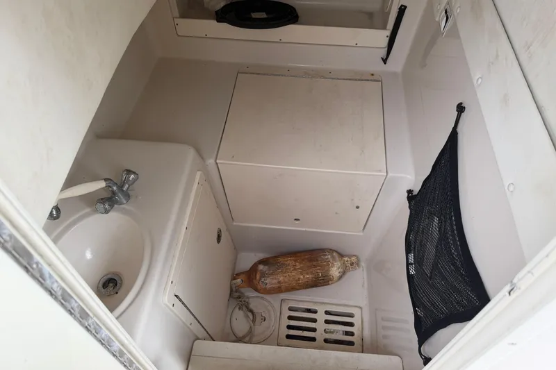 Slide: The Image of 2007 Cobia 312 Sport Cabin interior with sink, storage, and netting. - 9