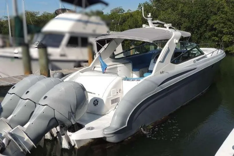 The Image of 2001 Formula 400 Super Sport boat docked with triple outboard engines. - 0