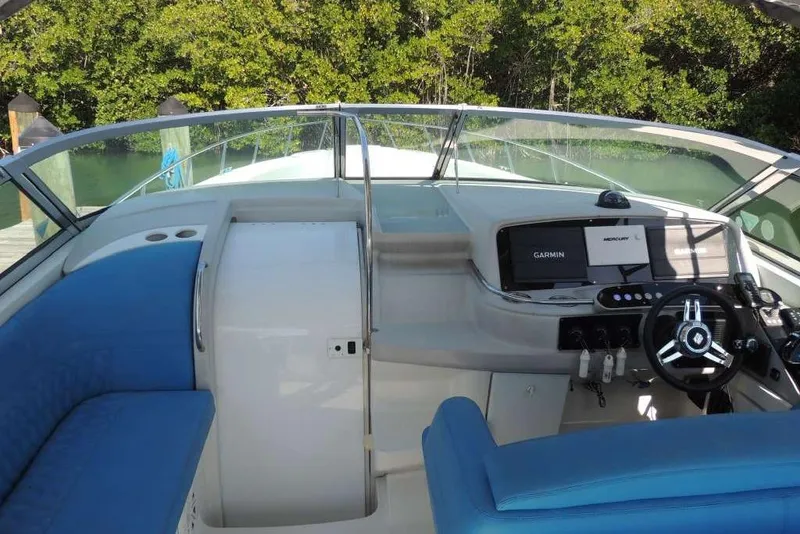 Slide: The Image of Cockpit of 2001 Formula 400 Super Sport boat with blue seating and navigation equipment. - 10