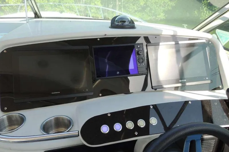 Slide: The Image of Dashboard of a 2001 Formula 400 Super Sport boat with Garmin displays. - 13