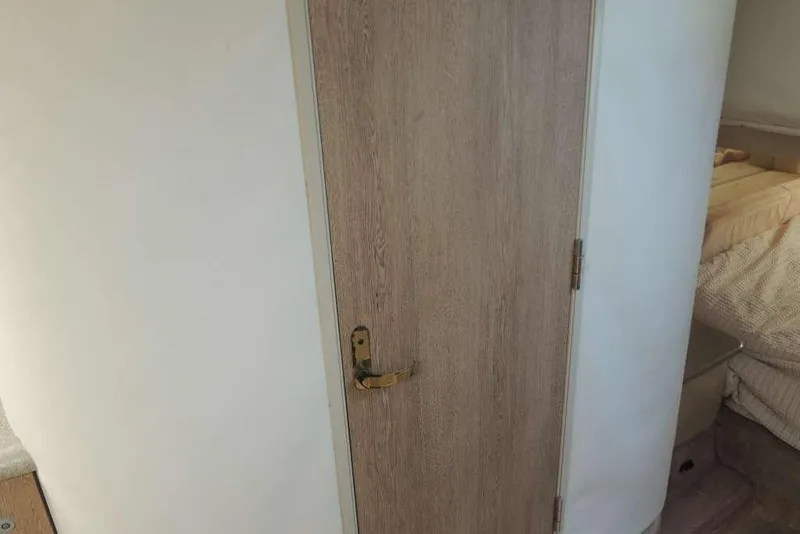 Slide: The Image of Wooden door inside 2001 Formula 400 Super Sport boat cabin. - 18