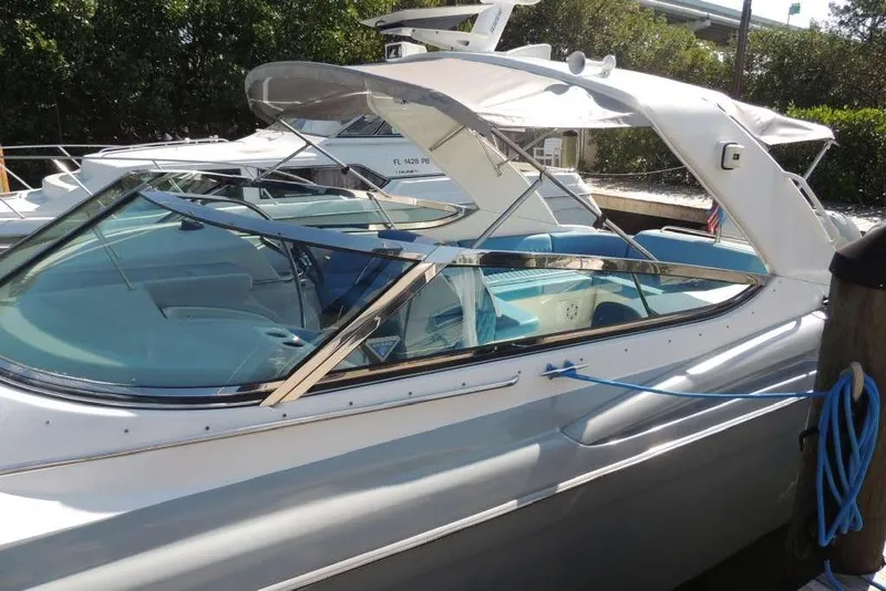 Slide: The Image of 2001 Formula 400 Super Sport boat docked with blue interior and canopy. - 2