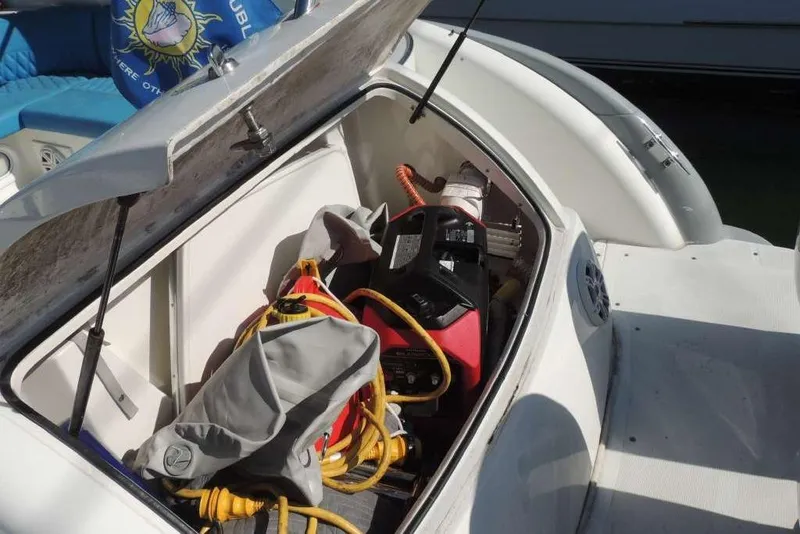 Slide: The Image of Open storage compartment on a 2001 Formula 400 Super Sport boat with various equipment. - 24