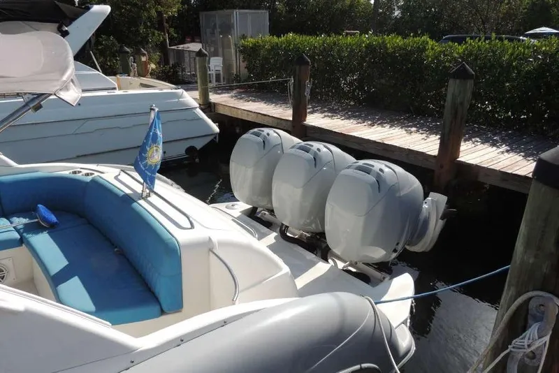 Slide: The Image of 2001 Formula 400 Super Sport boat with triple outboard engines docked by a wooden pier. - 3