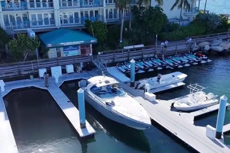 Slide: The Image of 2001 Formula 400 Super Sport yacht docked with jet skis. - 31