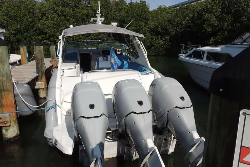 Slide: The Image of 2001 Formula 400 Super Sport boat docked with triple outboard engines. - 5