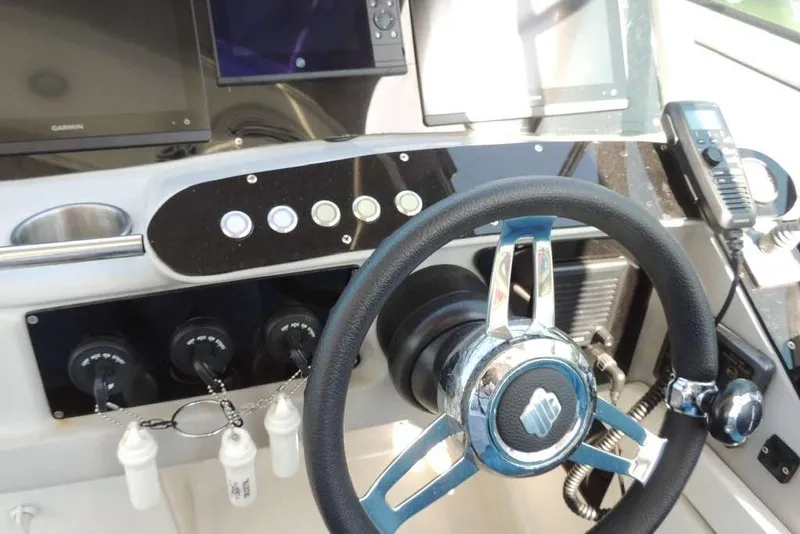Slide: The Image of Dashboard of a 2001 Formula 400 Super Sport boat with steering wheel and controls. - 6