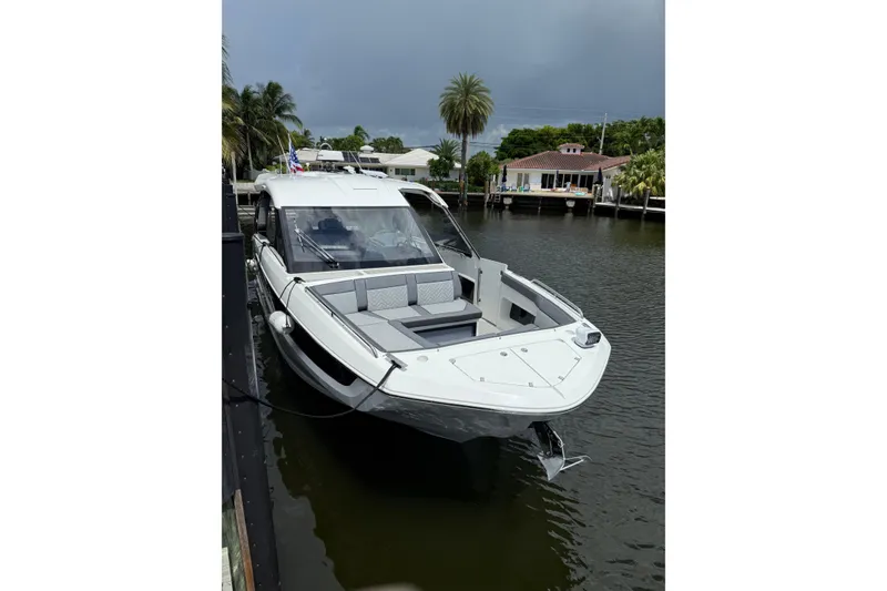 Slide: The Image of 2024 Galeon 325 GTO luxury yacht docked on a serene waterfront. - 2