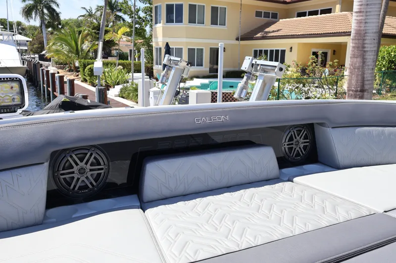 Slide: The Image of Luxurious seating area on the 2024 Galeon 325 GTO yacht, docked near a waterfront property. - 69