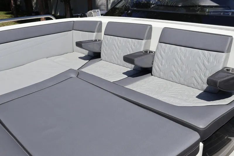 Slide: The Image of 2024 Galeon 325 GTO boat interior with speakers, luxury seating, and palm trees in the background. - 72