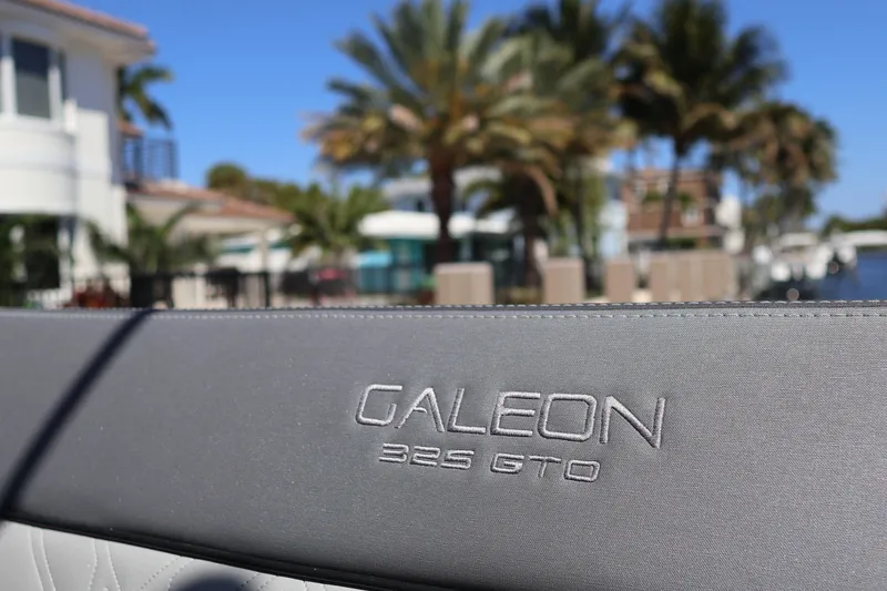 Slide: The Image of 2024 Galeon 325 GTO boat seating with gray upholstery and cup holders. - 74