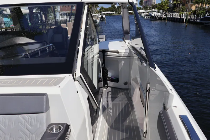 Slide: The Image of 2024 Galeon 325 GTO luxury yacht with sleek design, docked by waterfront homes. - 76
