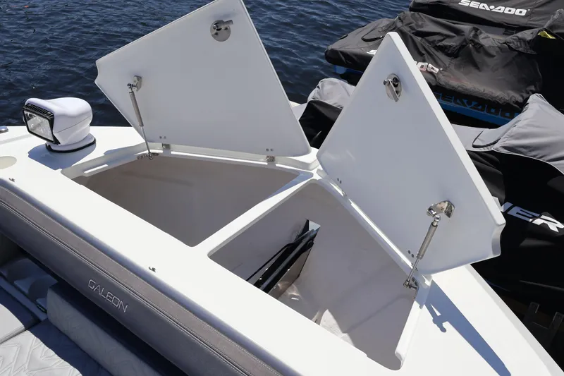 Slide: The Image of 2024 Galeon 325 GTO boat deck with storage compartments and spotlight, docked near WaveRunner. - 80