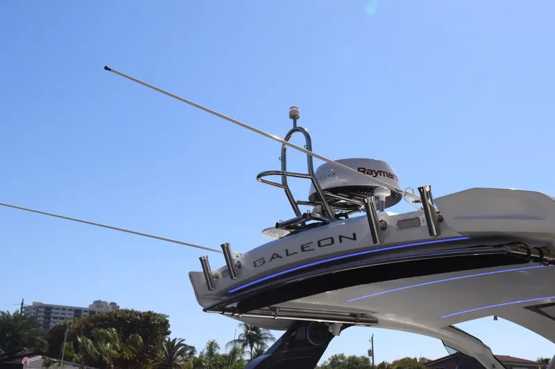 Slide: The Image of 2024 Galeon 325 GTO yacht docked, surrounded by palm trees and clear blue sky. - 87