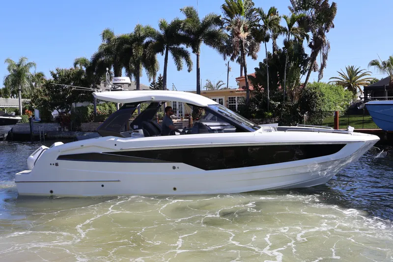 Slide: The Image of 2024 Galeon 325 GTO yacht with radar and antennas against clear blue sky. - 88