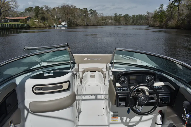 Slide: The Image of 2019 Crownline Eclipse E255 SURF boat interior on a serene river. - 10