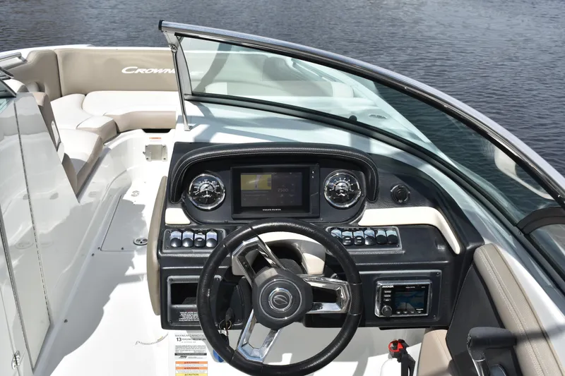 Slide: The Image of 2019 Crownline Eclipse E255 SURF boat dashboard with steering wheel and controls. - 11