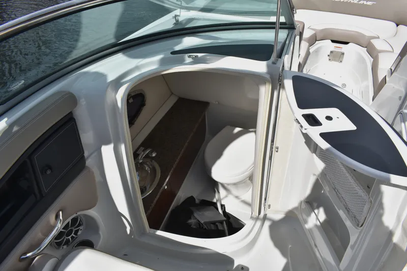 Slide: The Image of 2019 Crownline Eclipse E255 SURF boat interior with compact bathroom. - 13