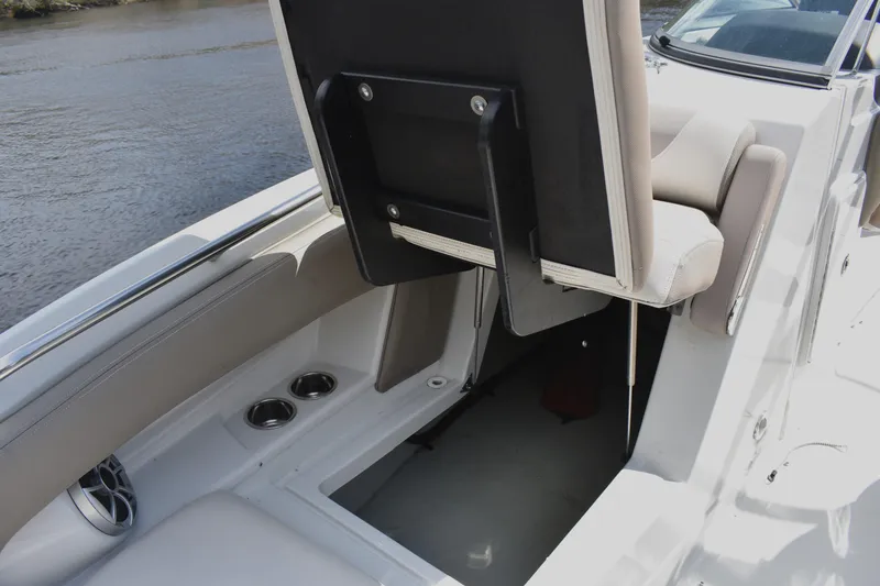 Slide: The Image of 2019 Crownline Eclipse E255 SURF boat interior with storage compartment and seating. - 7