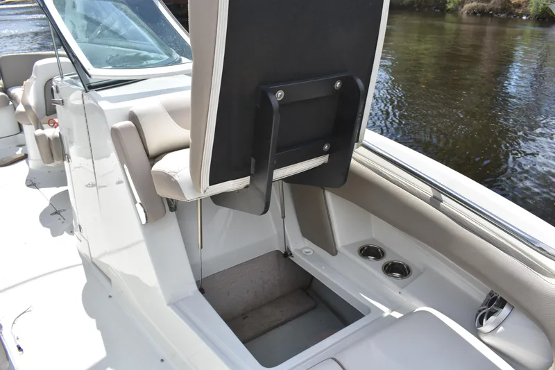 Slide: The Image of 2019 Crownline Eclipse E255 SURF boat interior with storage compartment open. - 8