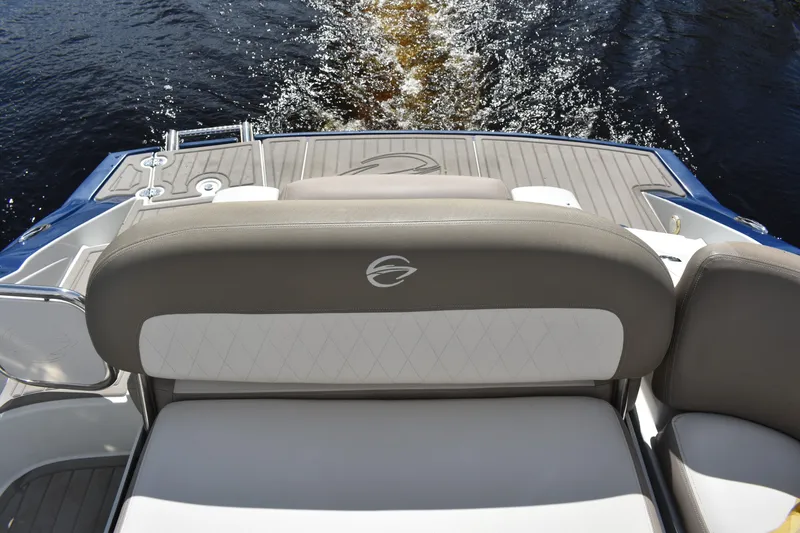 Slide: The Image of 2019 Crownline Eclipse E255 SURF boat with cushioned seating and water view. - 9